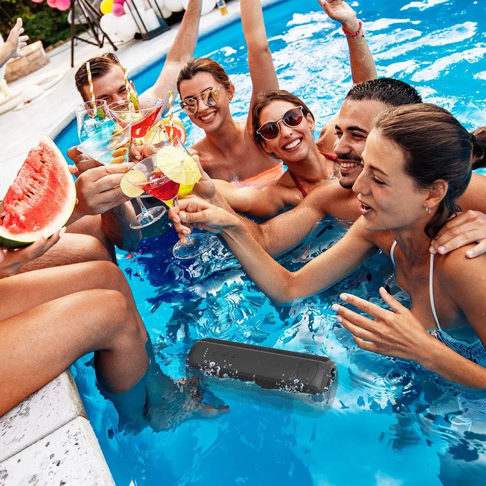 GLOWBEATS Wireless Bluetooth Speaker, Black, Floating on water, with a group of friends partying in the pool.